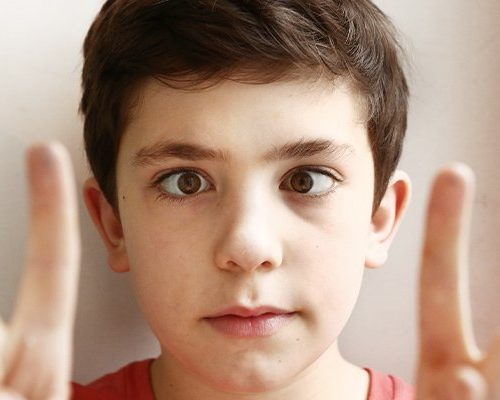 preteen-handsome-boy-play-squinting-trick-with-his-eyes-and-fingers-close-Diagnoses-and-Treatments-ss-body